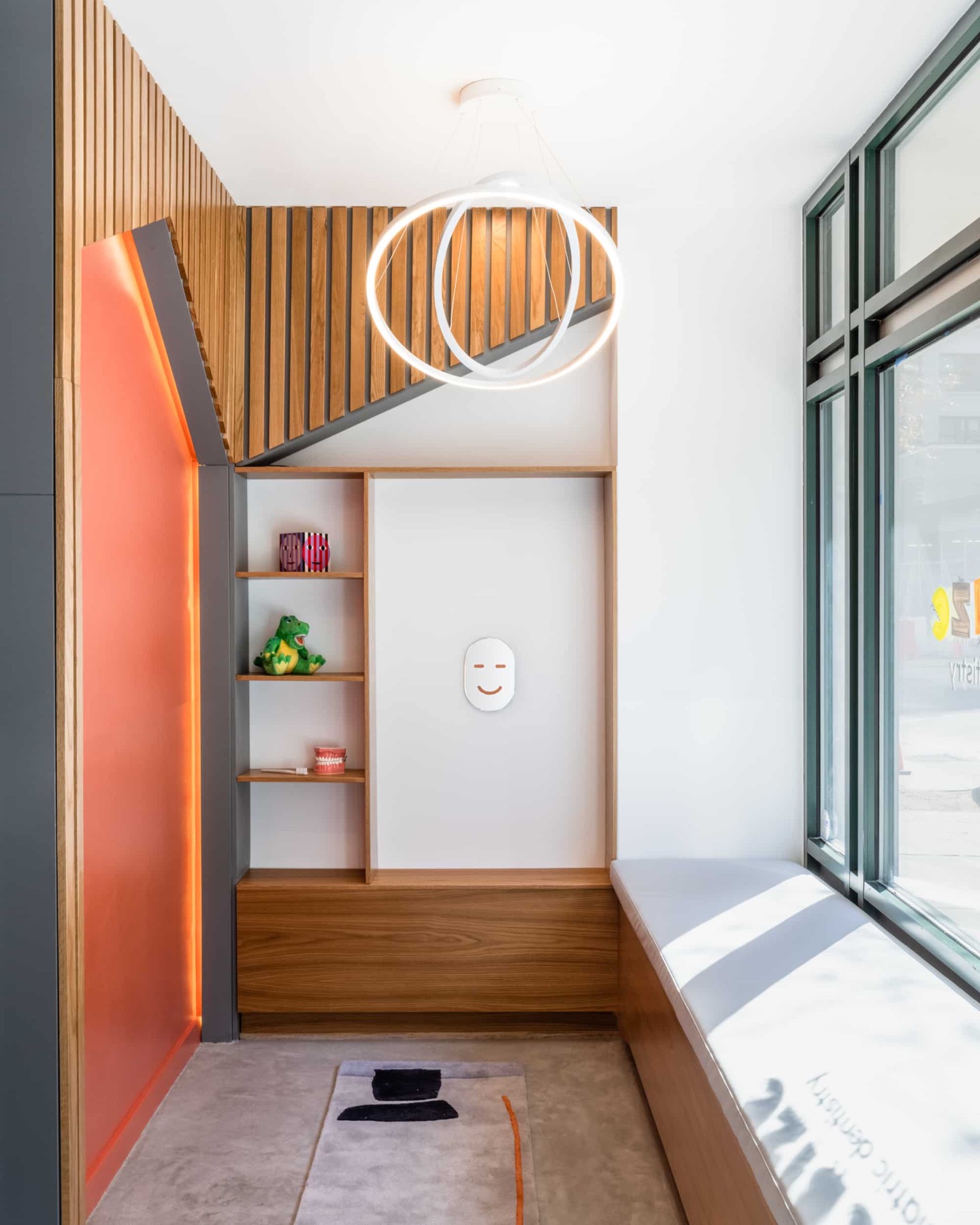A Bitesize treatment area with white cabinetry, a dental chair and bright wall color, photographed at the DUMBO office